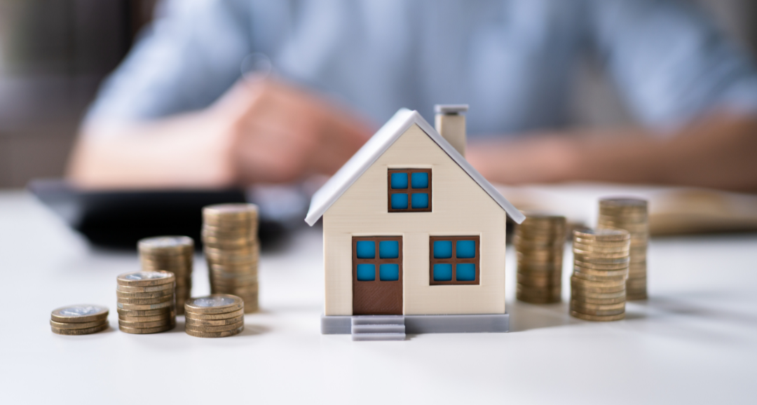 Home insurance little house on table with coins money