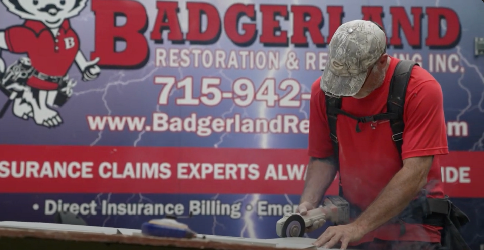 Contractor installing siding in Waupaca WI at Badgerland Restoration & Remodeling