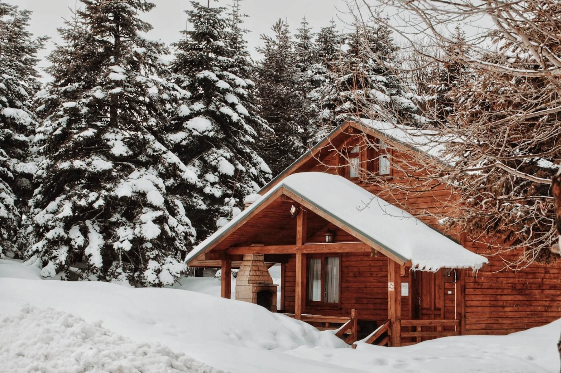 Snow covered roof on log cabin after snow storm in Northern Wisconsin