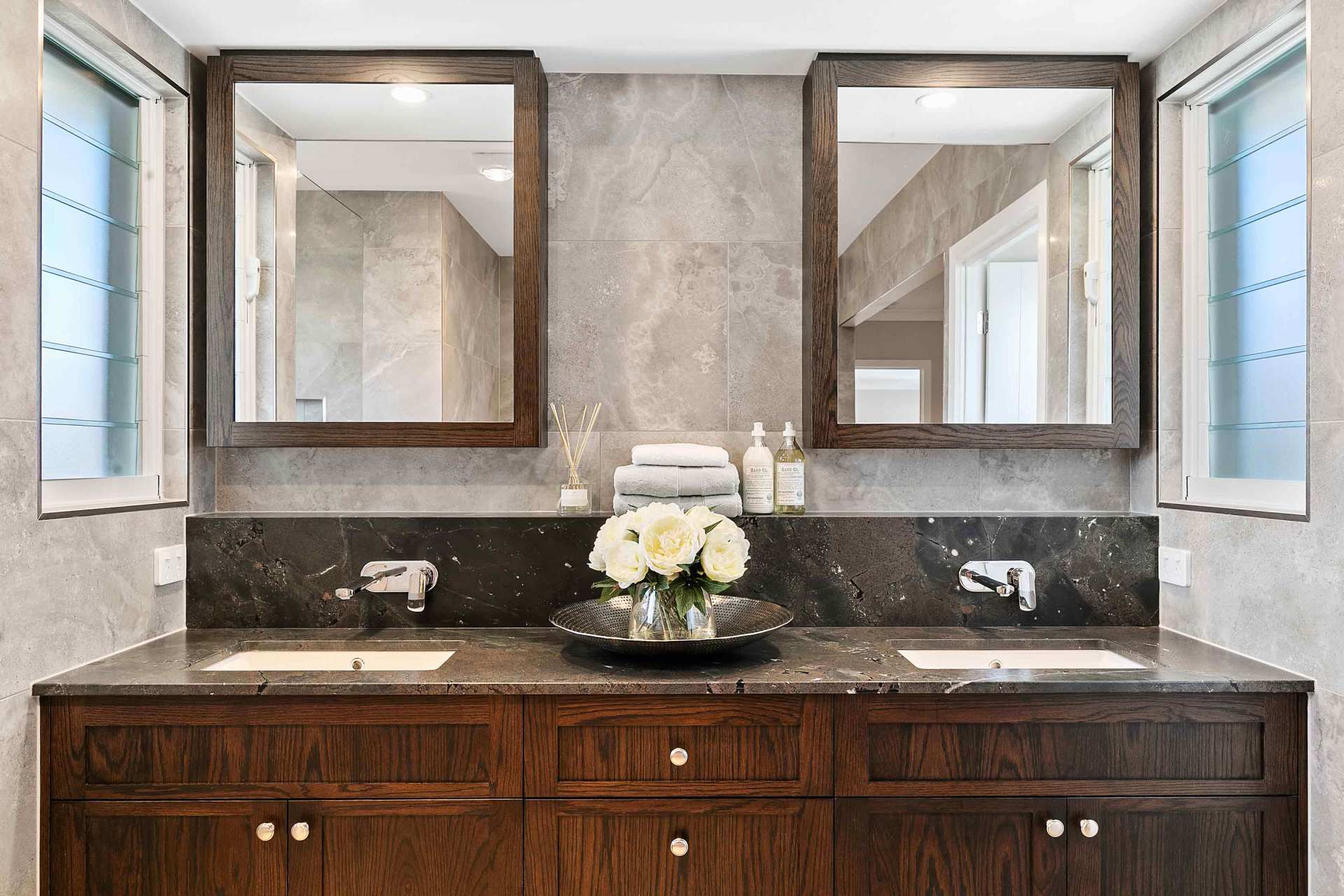 two mirrors and cabinet