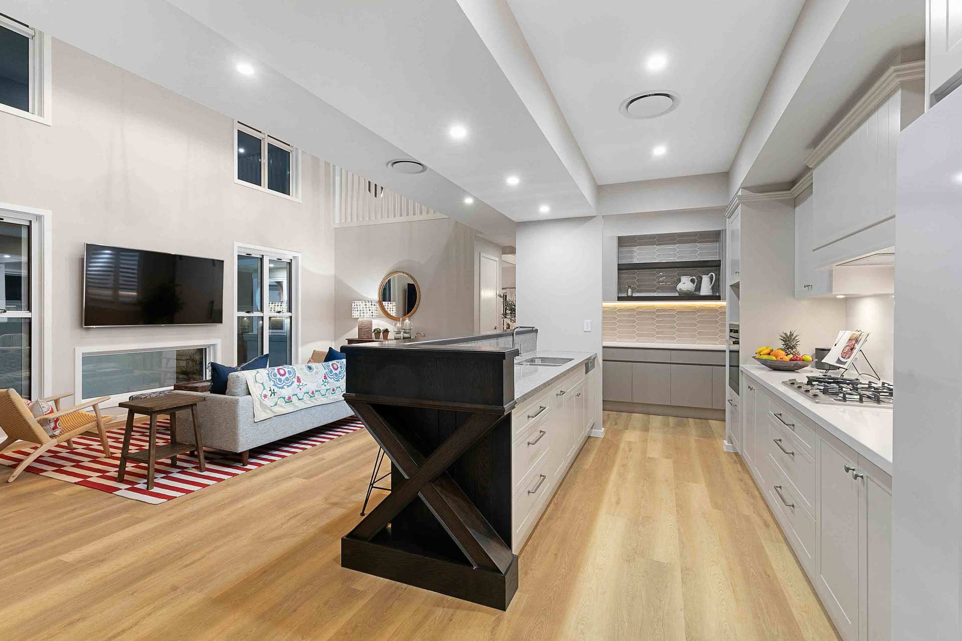 chairs, tv in walls, mirrors, kitchen