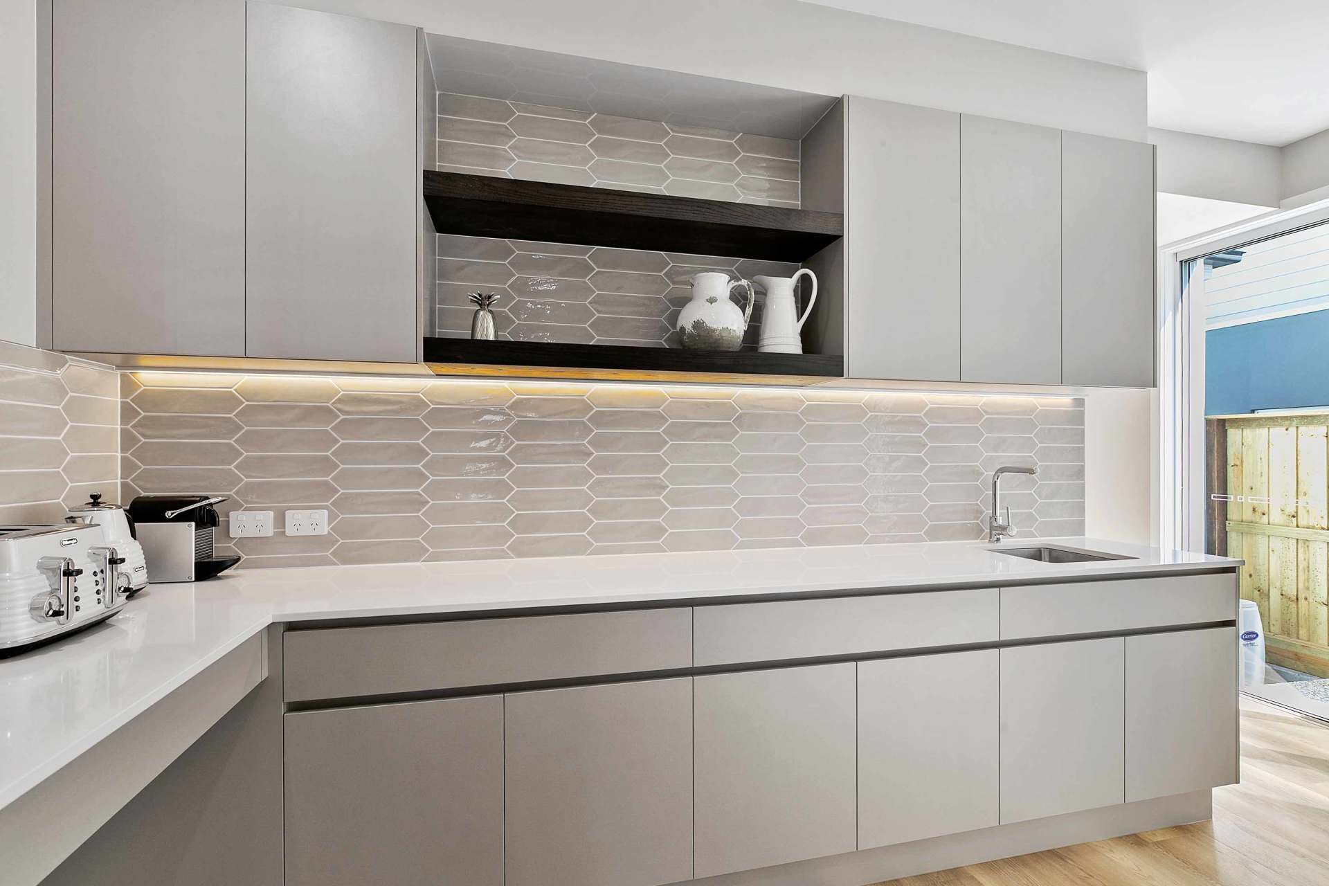 kitchen with white tiles and cabinet
