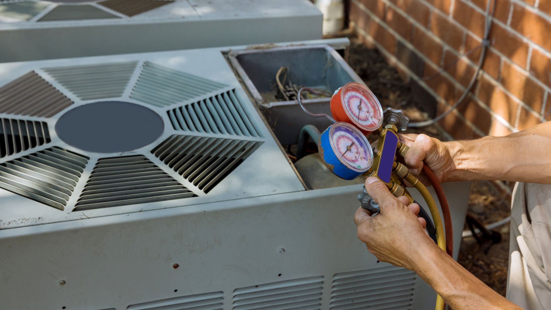 A white air conditioner is mounted on the side of a building.