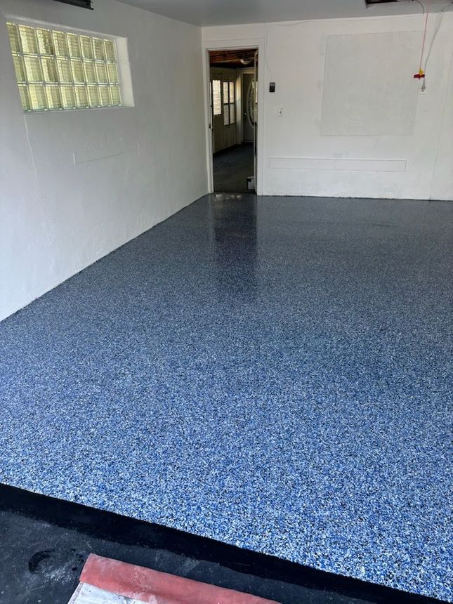 A garage with a blue floor and white walls.