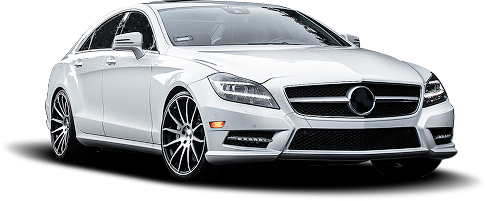 A white Mercedes-Benz CLS-Class sedan with custom dark, multi-spoke wheels, viewed from a front-quarter angle. | Airpark Auto Pros