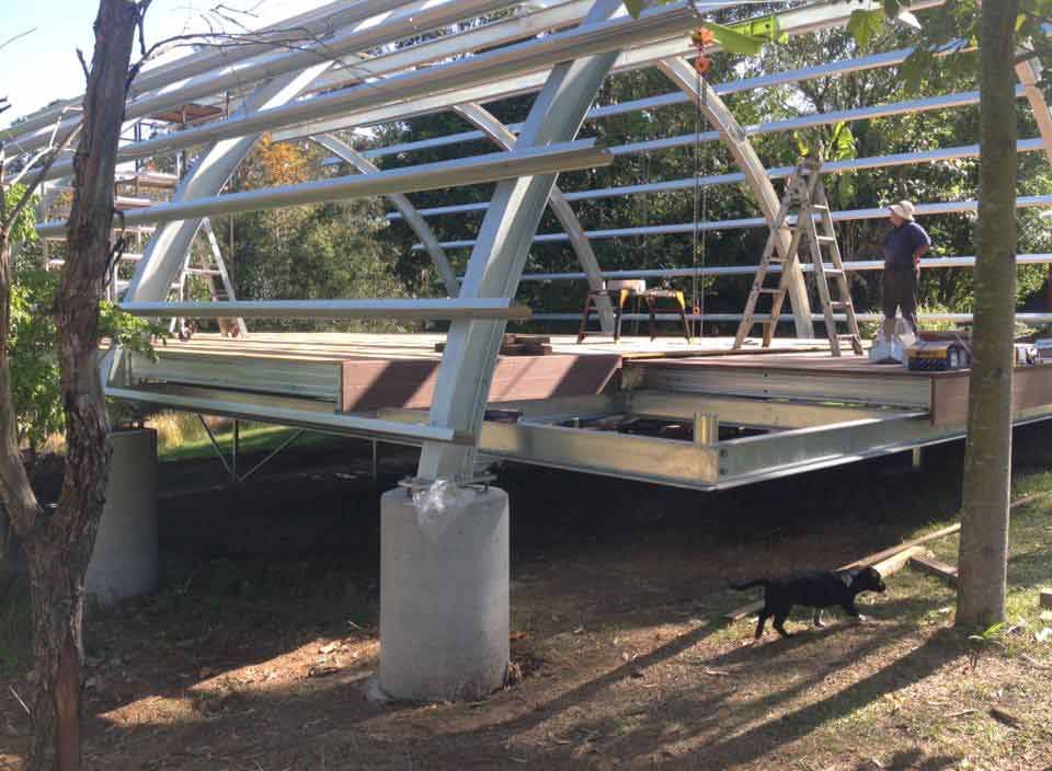 A Dog Is Walking Under A Bridge That Is Being Built — Primmer Steel In Taree, NSW