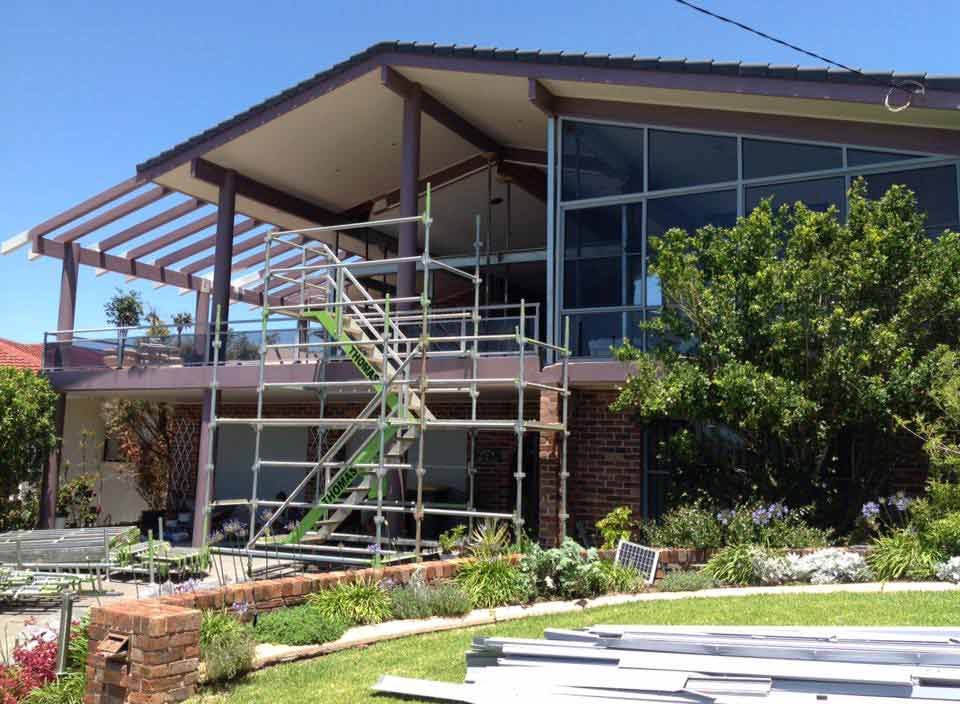 A House With Scaffolding In Front Of It Is Being Remodelled — Primmer Steel In Port Macquarie, NSW