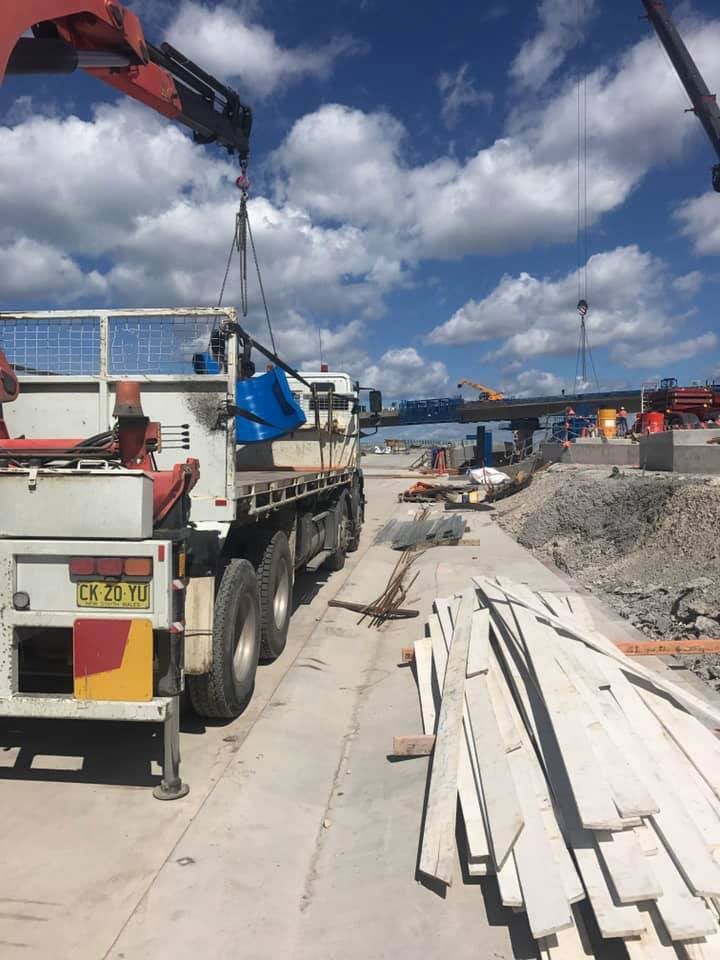 A Truck Is Being Lifted By A Crane On A Construction Site — Primmer Steel In Nabiac, NSW