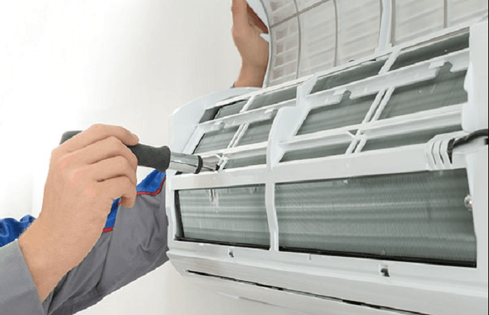 A professional running a service on an air conditioner in Coffs Harbour