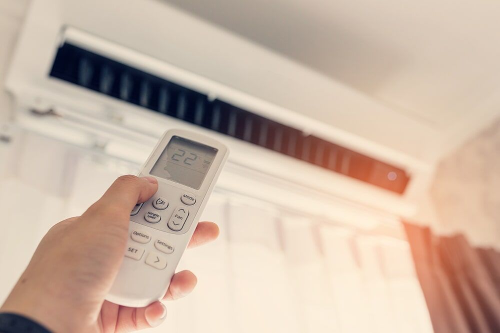 An air conditioner remote in use in Coffs Harbour