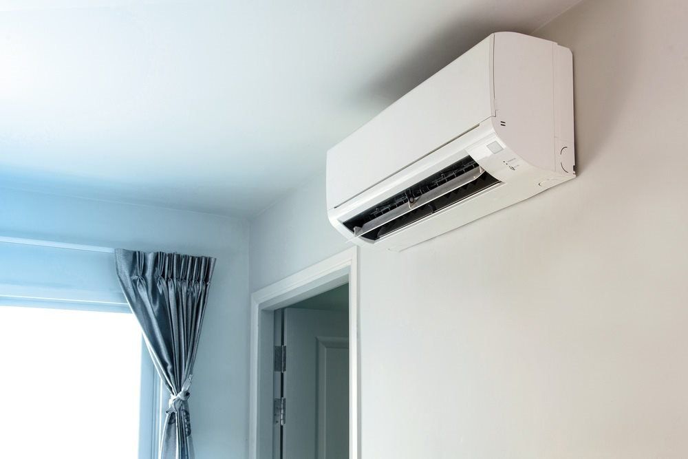 split system air conditioner mounted on white wall