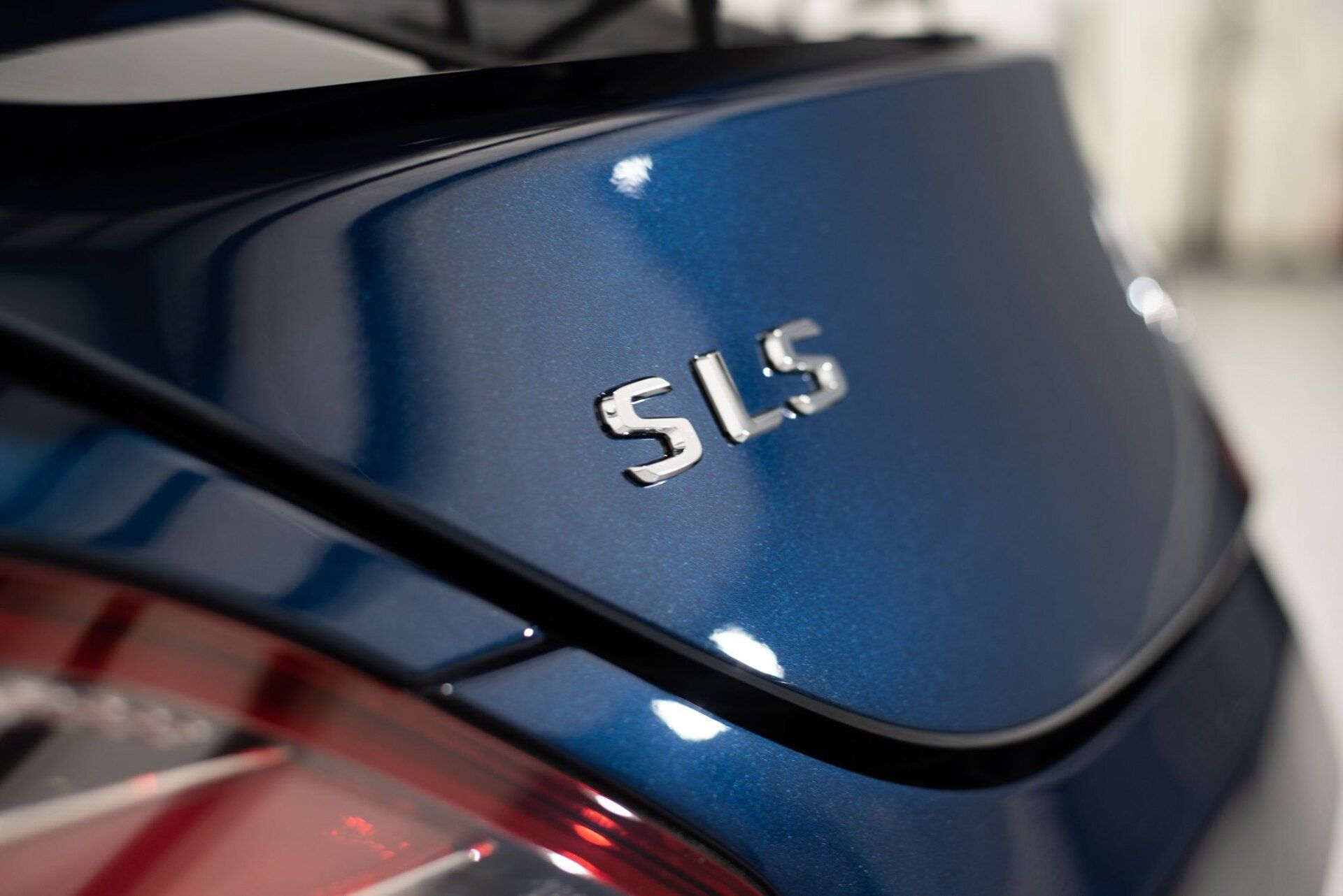 A close up of the back of a blue sls car
