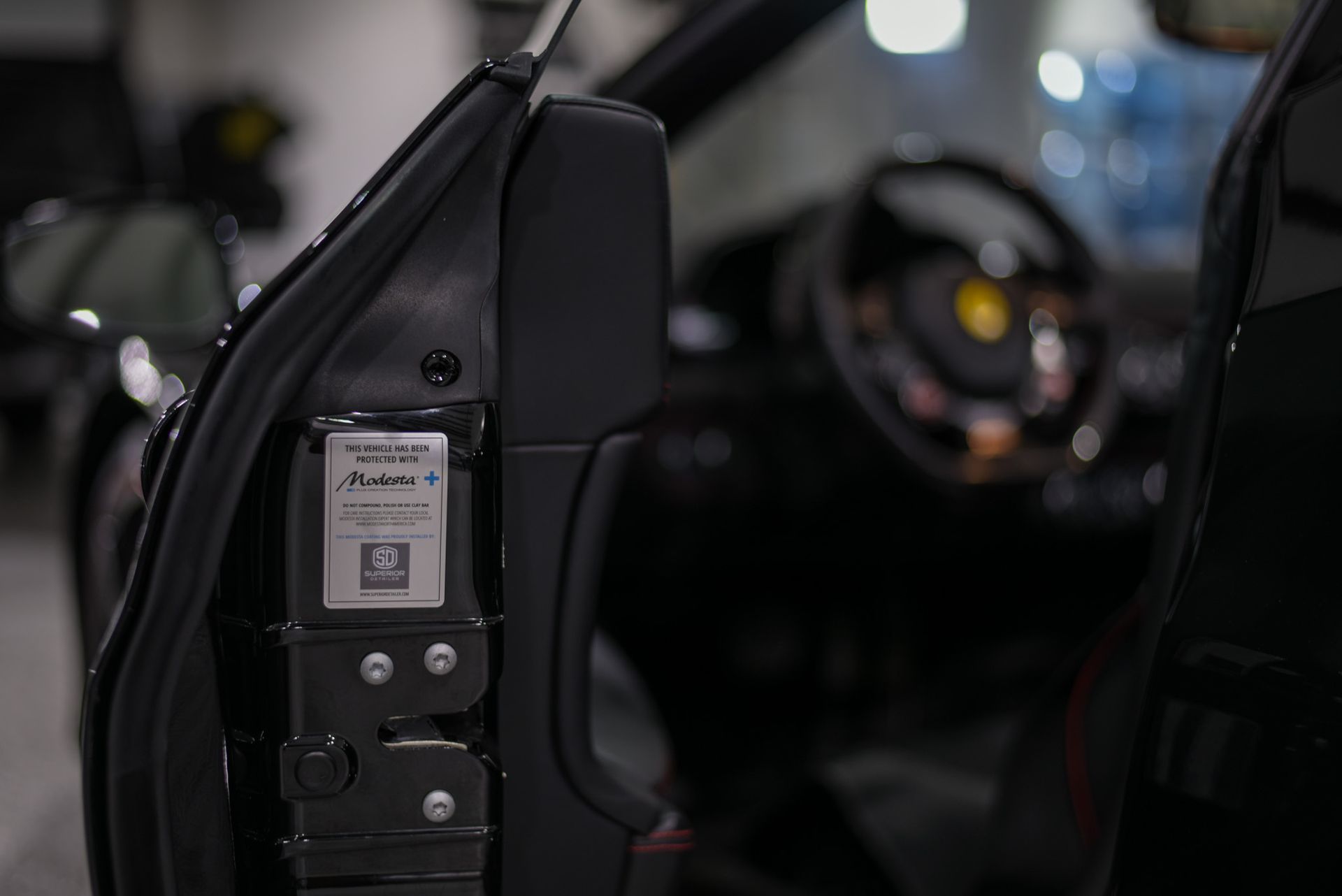 A close up of a black car with the door open