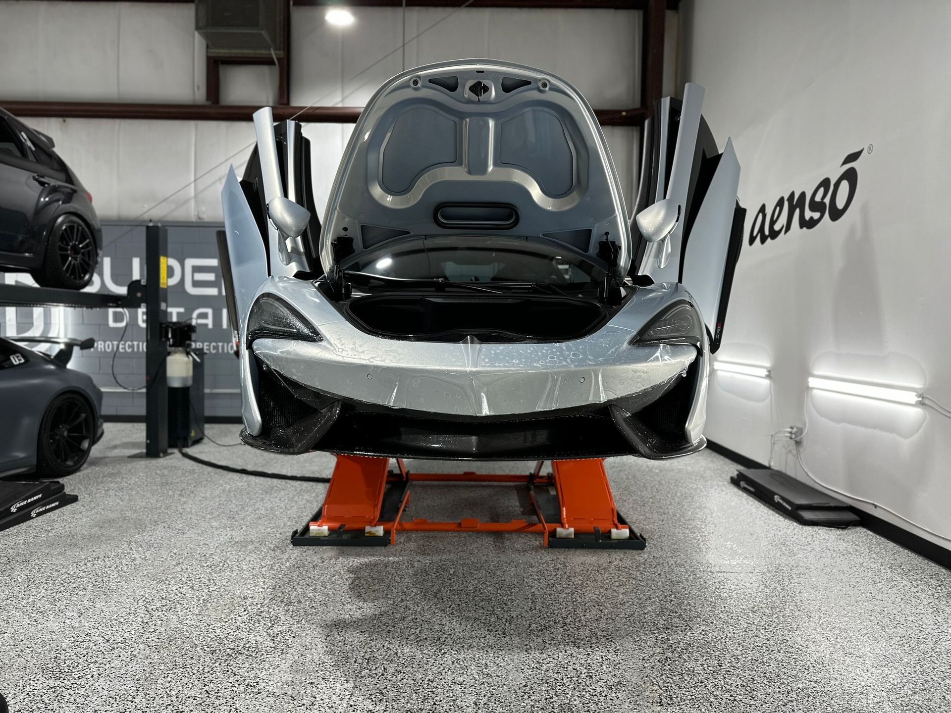 2016 McLaren 570 SunTek Reaction PPF, Modesta Maintenance Detail, and Modesta BC06 Wheel and Caliper Coating hood and doors open Orlando, FL USA