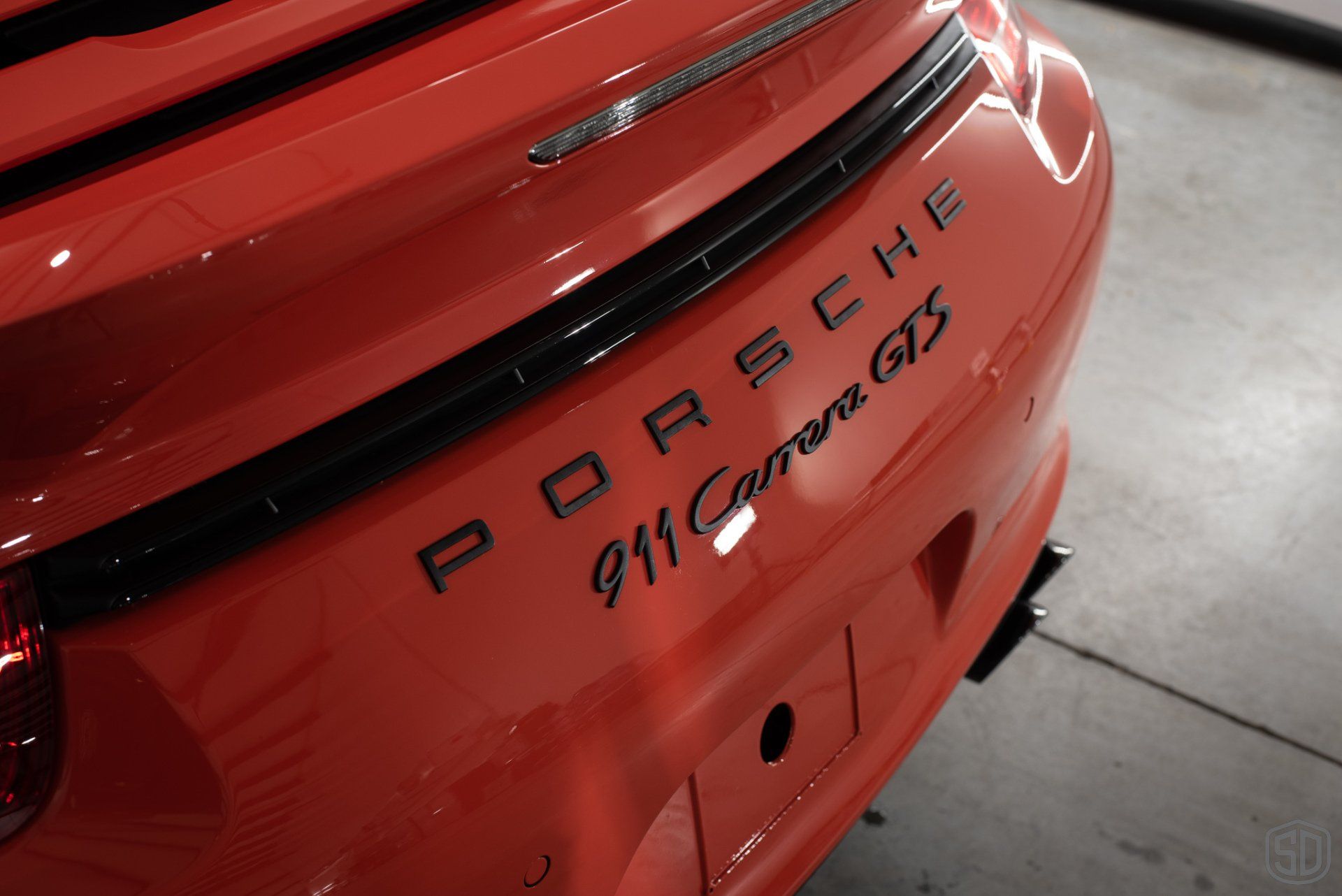 2016 Porsche 911 GTS Detailing, Paint Correction, Paint Chip Repair, Nano-Titanium Glass Coating, Paint Protection Film badge close up Orlando FL