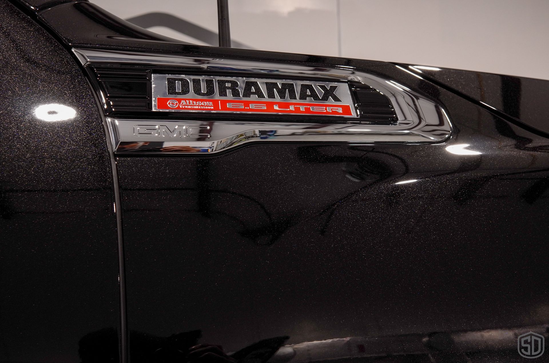 A black truck with the word duramax on the side