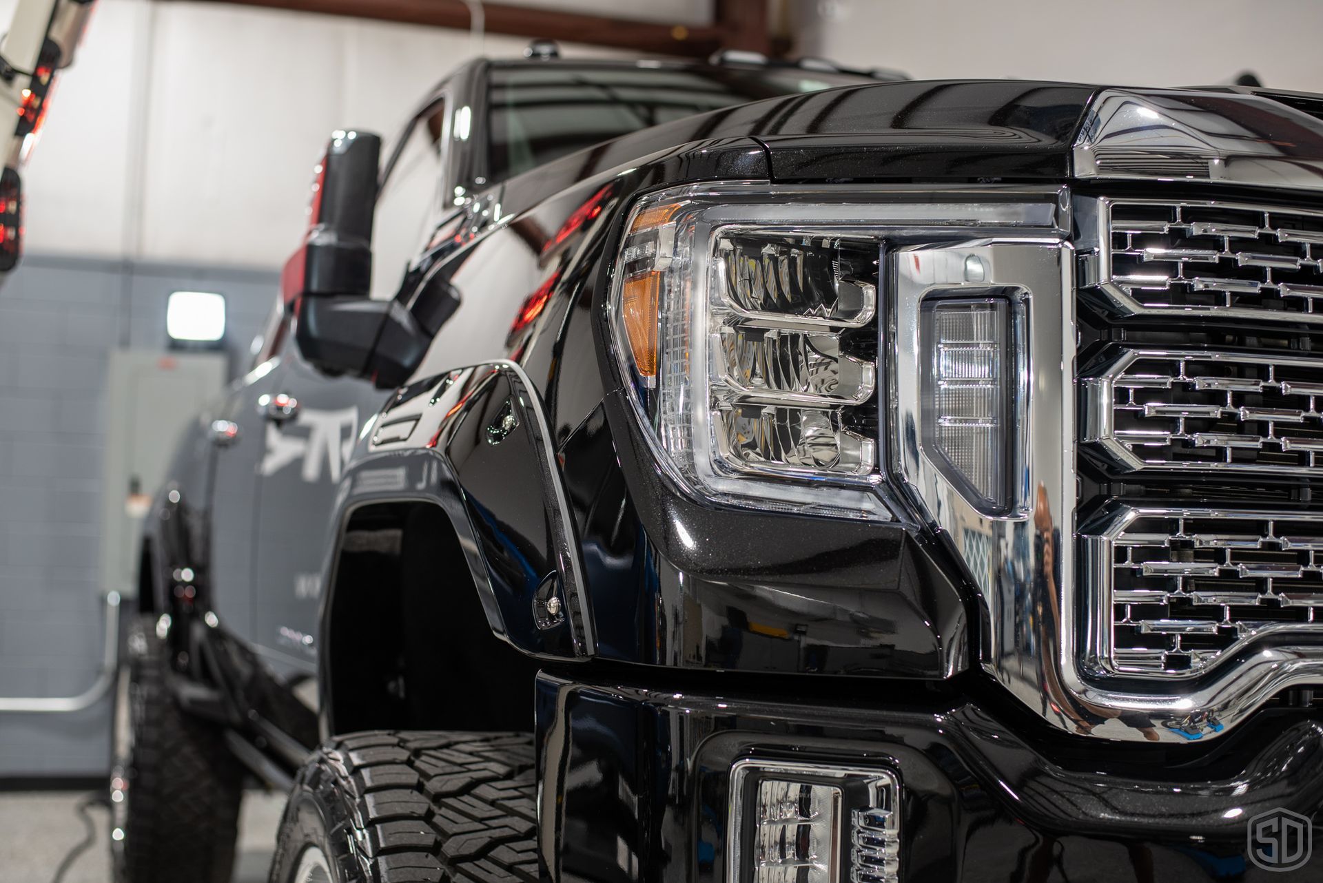 A black pickup truck is parked in a garage.