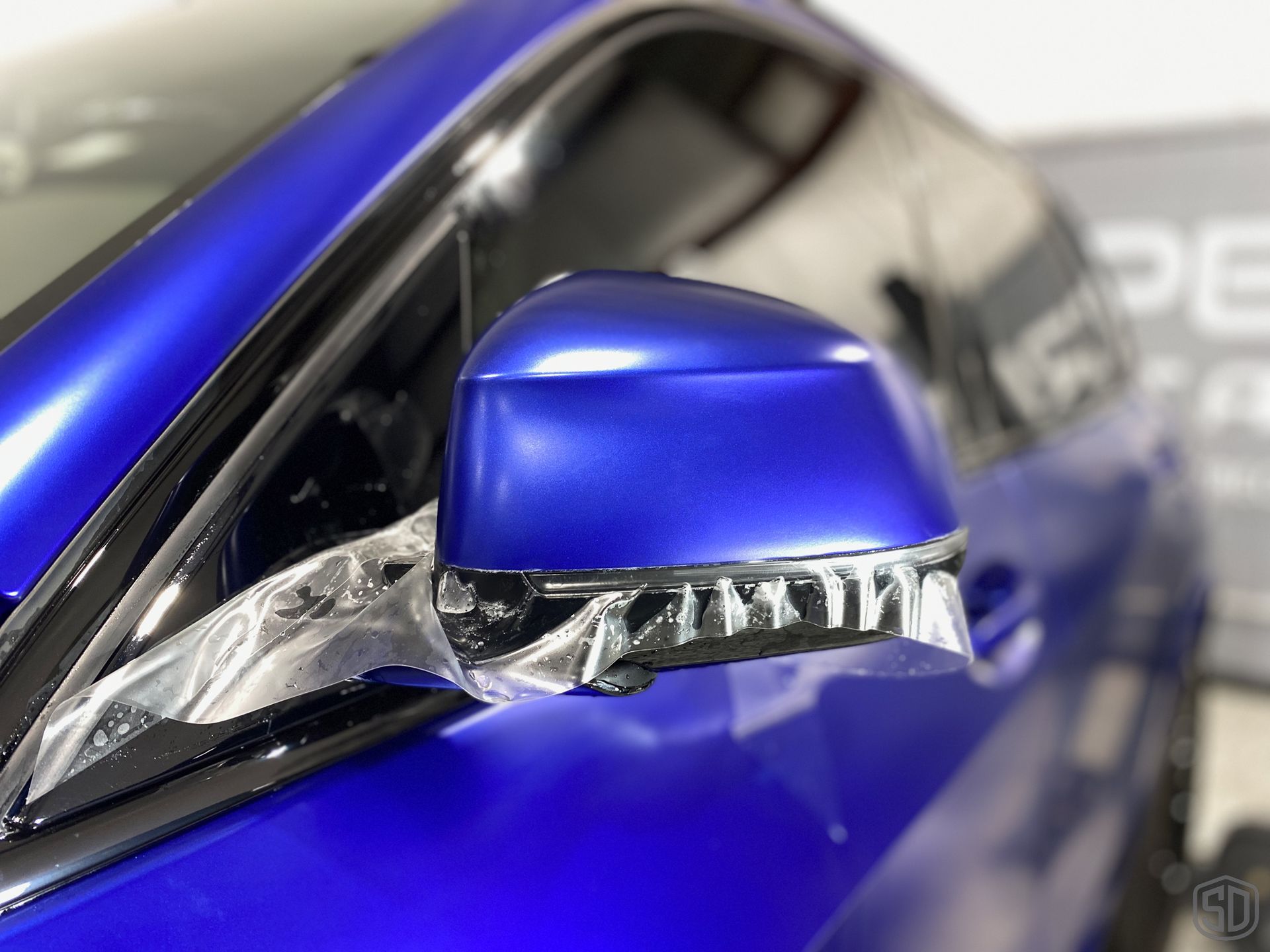 2023 BMW X5 M50i Paint Protection Film and Modesta Matte Coating BC-M and Brake Calipers and Wheels with BC-06 installation close up view of side mirror Florida