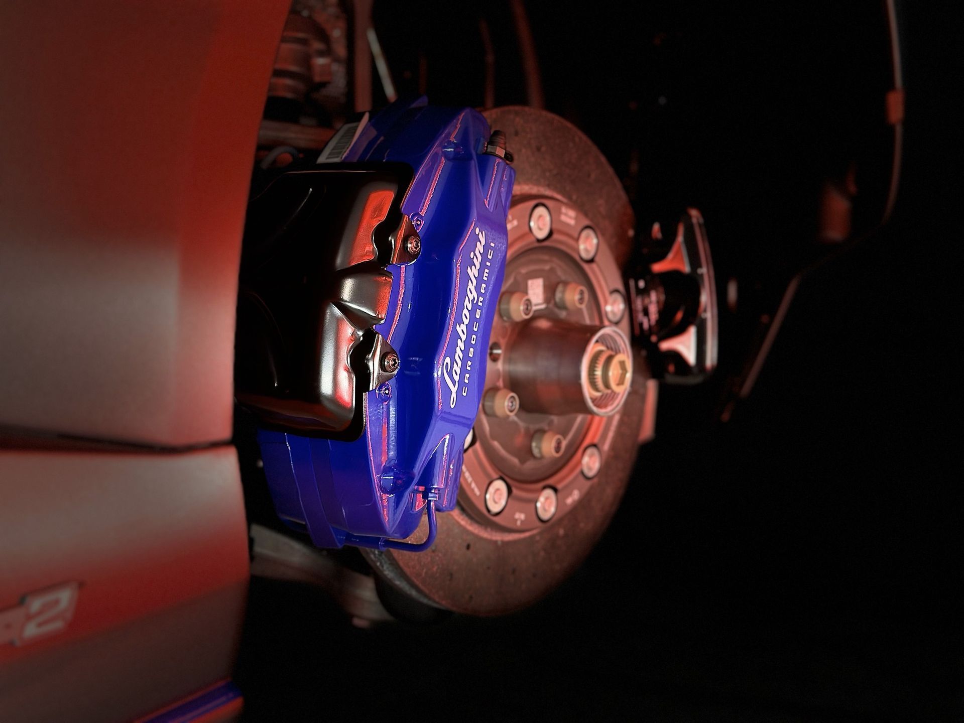 A close up of a blue brake caliper on a car.