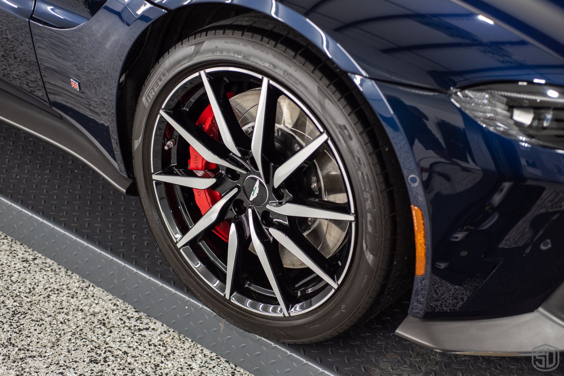 A close up of a car wheel with red brake calipers