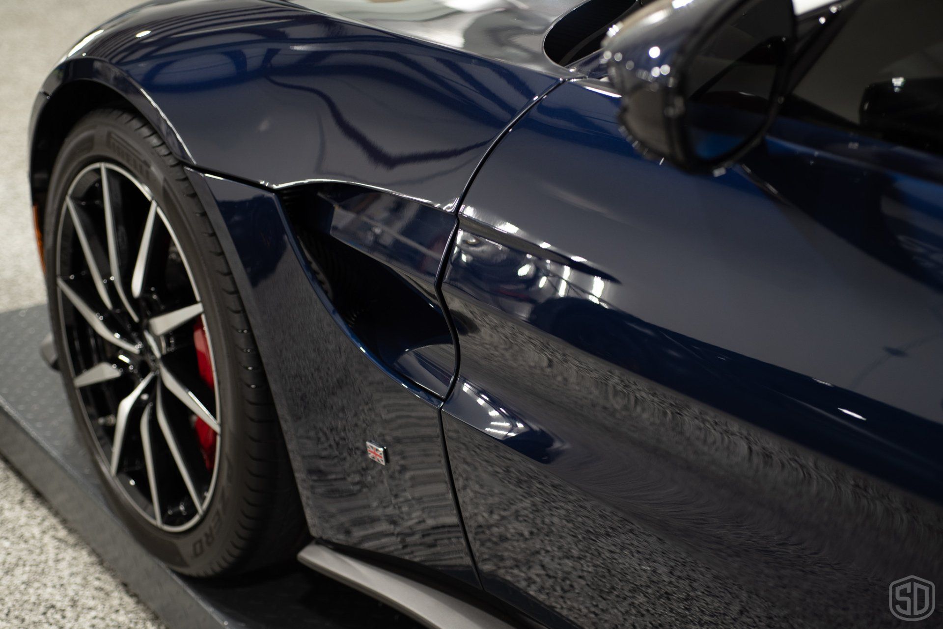 A close up of the side of a blue sports car