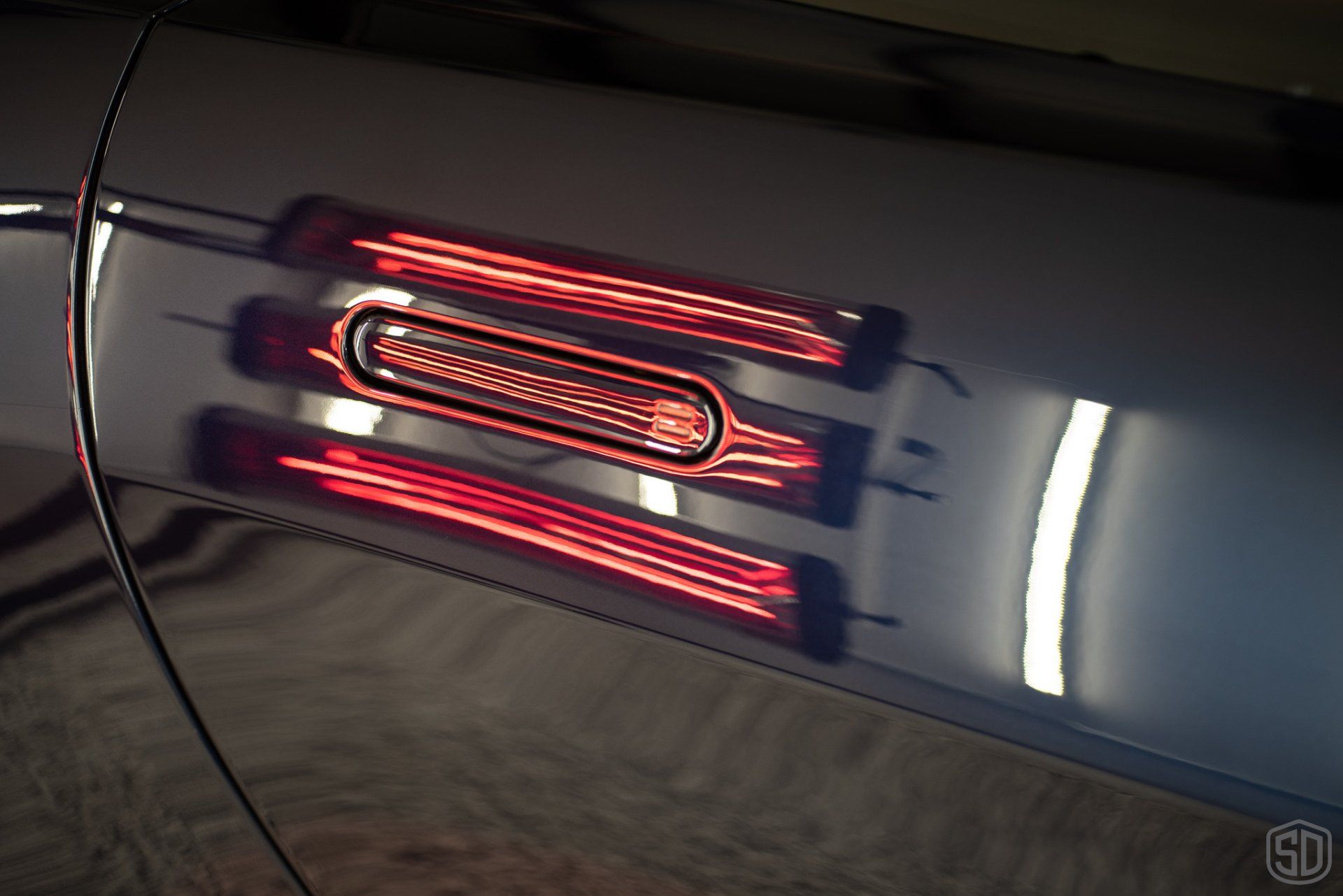 A close up of a red light on the side of a car