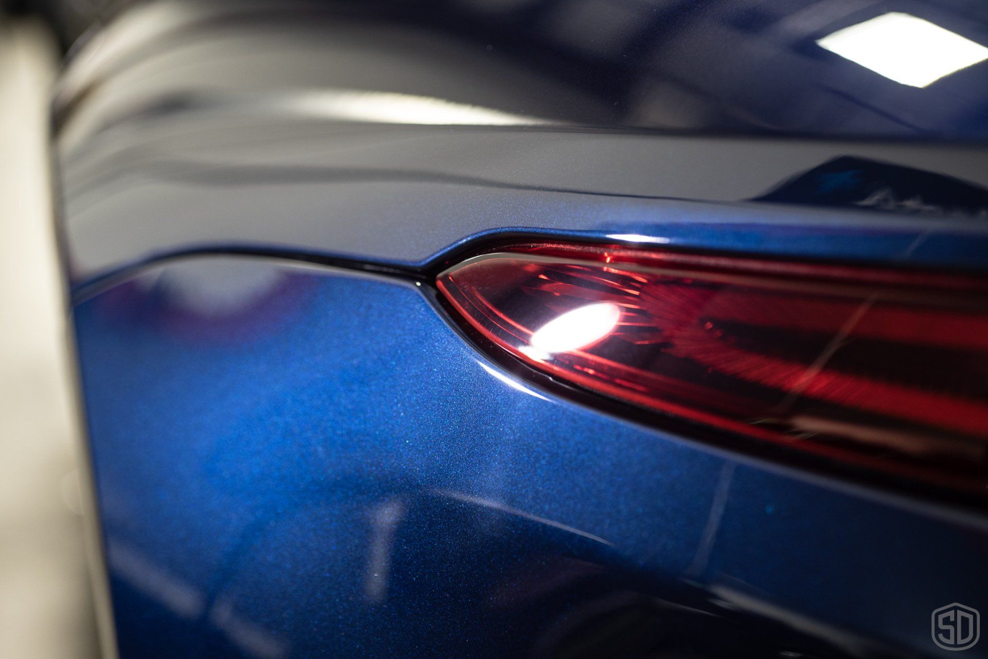 A close up of a blue car 's tail light.