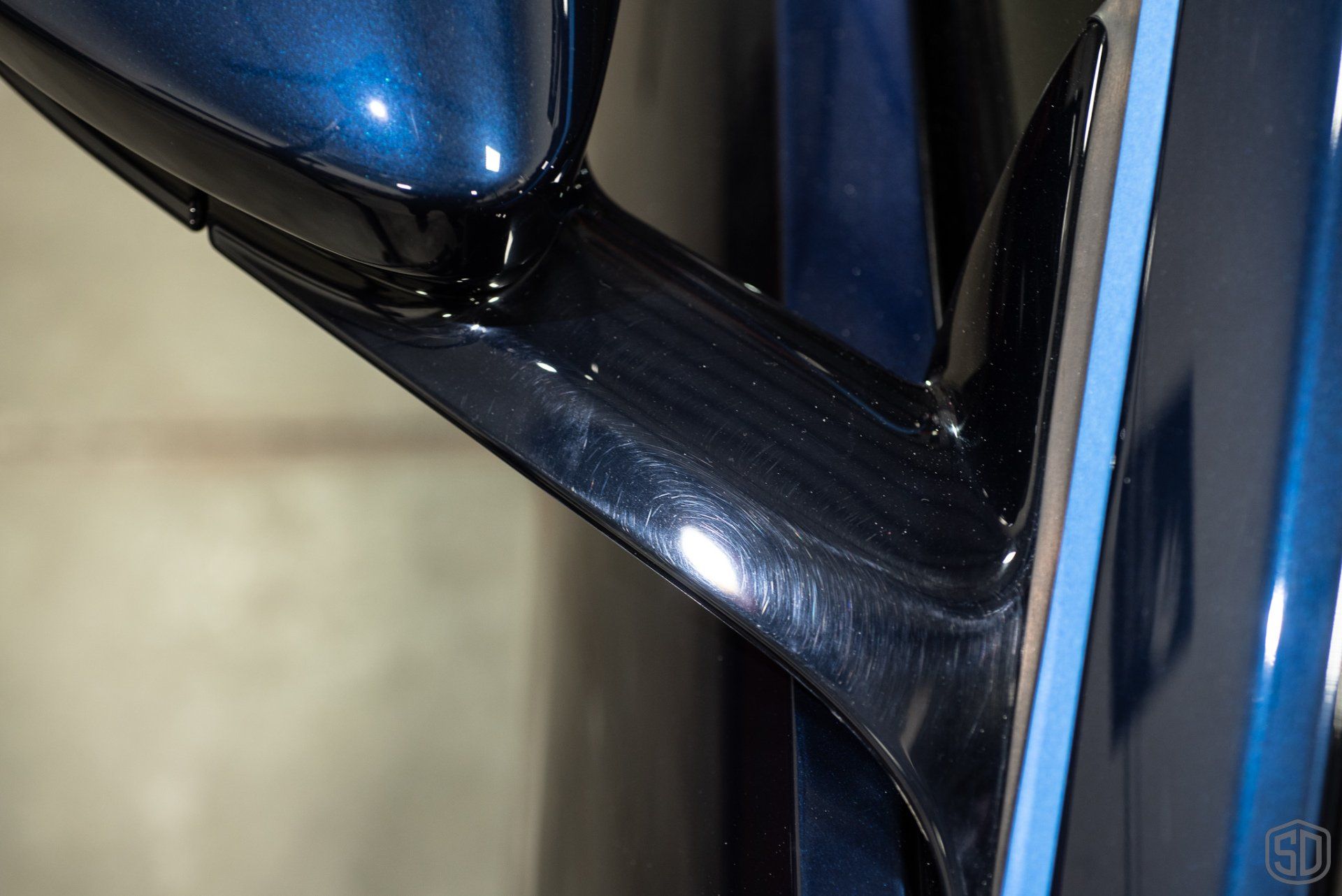 A close up of a blue car 's side mirror.