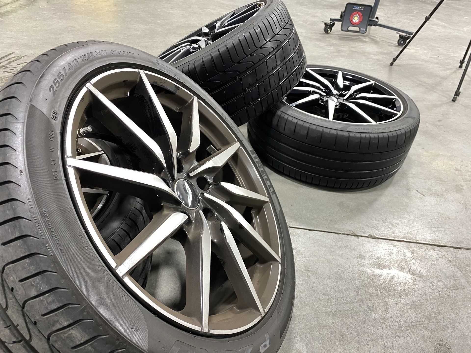 Three tires are stacked on top of each other on a concrete floor.