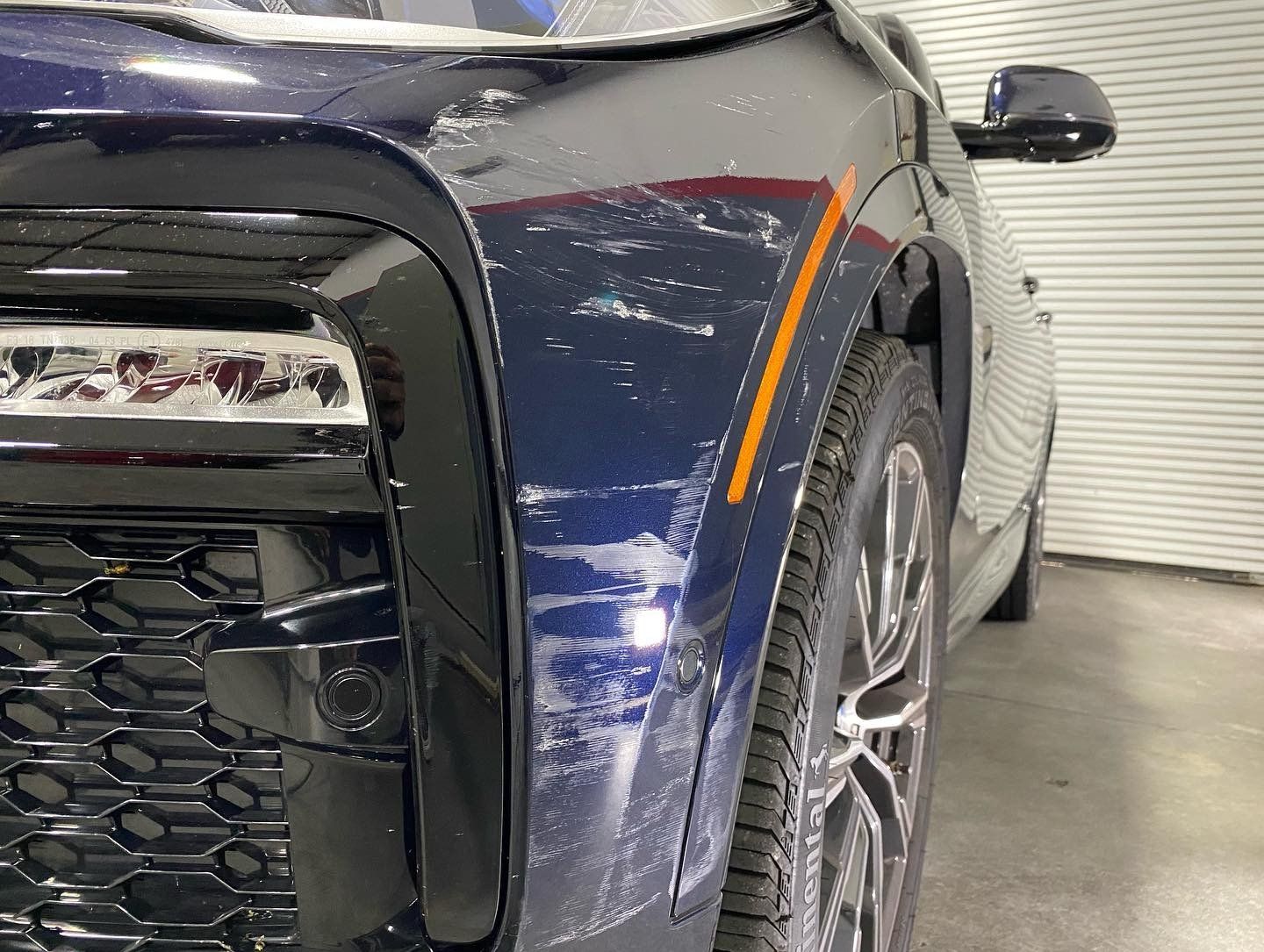 BMW X6 M50i Xpel Paint Protection Film and Modesta BC-05 front fender scratch detail before orlando FL