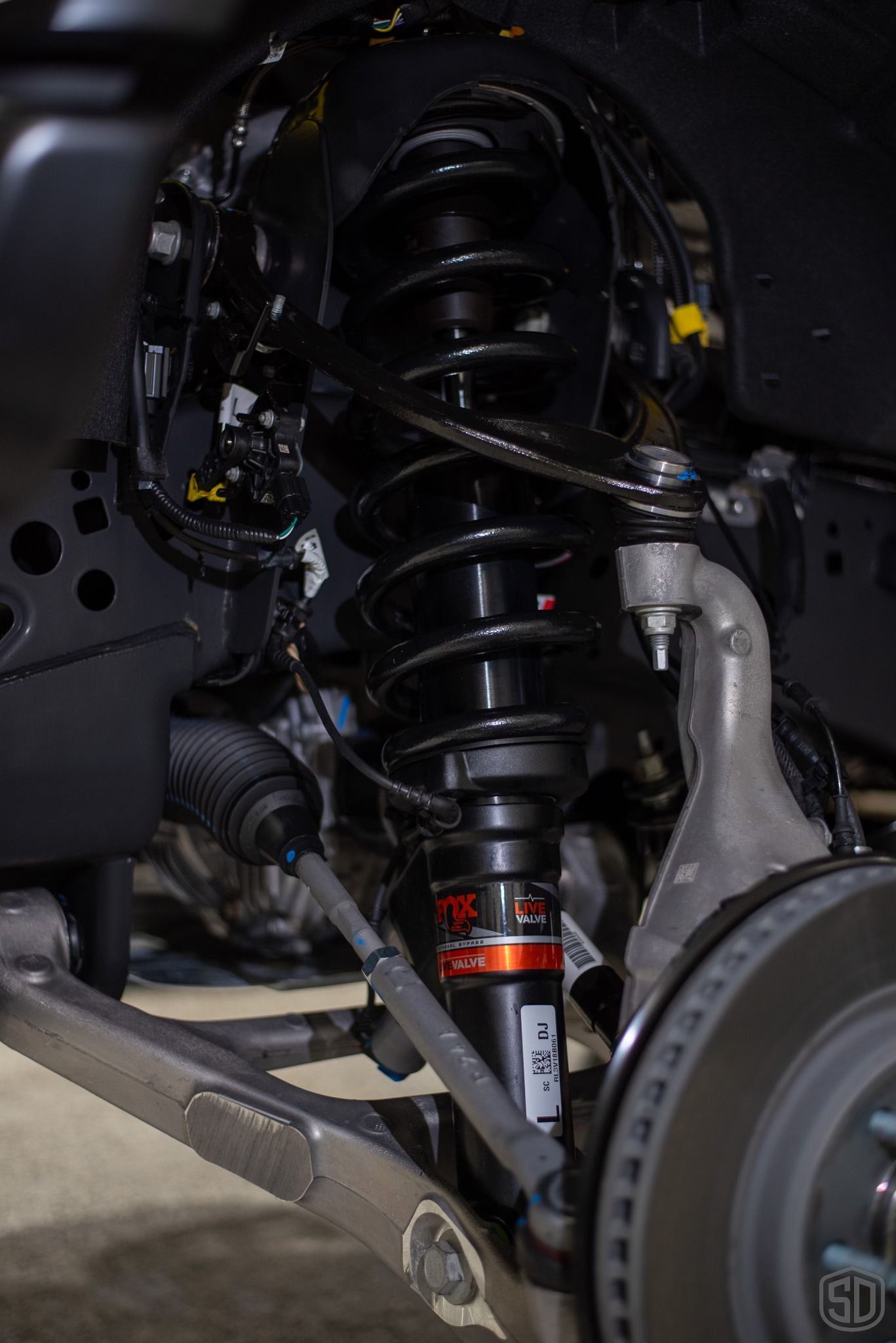 A close up of a shock absorber on a car.