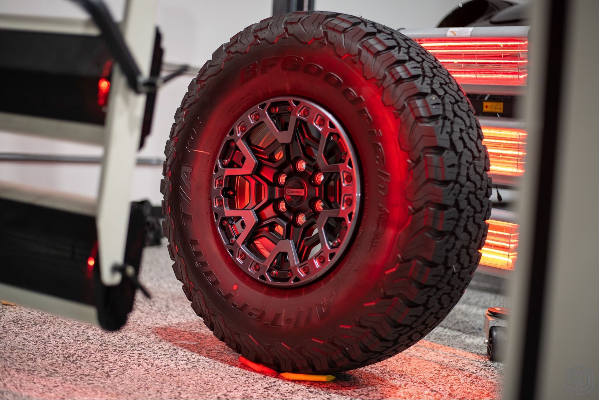 A close up of a tire with red lights on it.