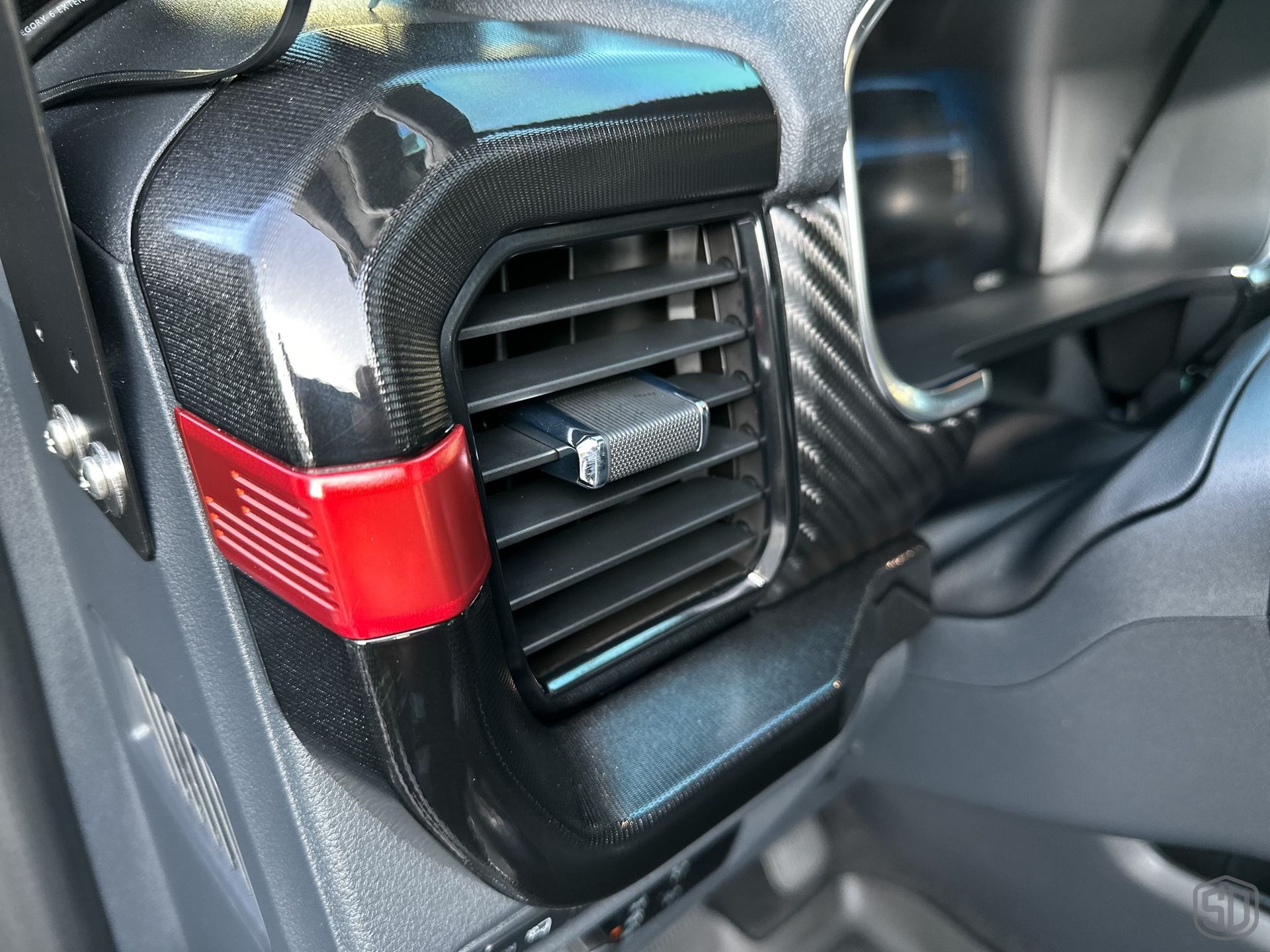 A close up of an air vent in a car