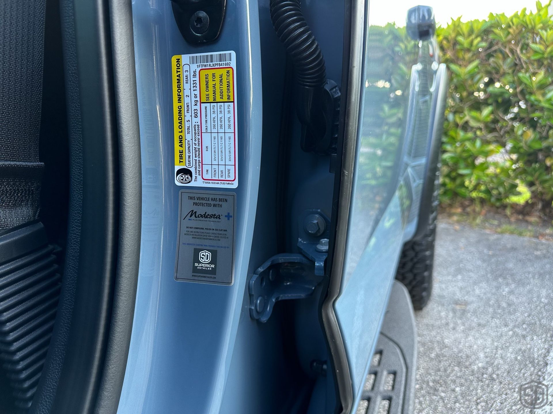 A close up of a car door with a sticker on it.