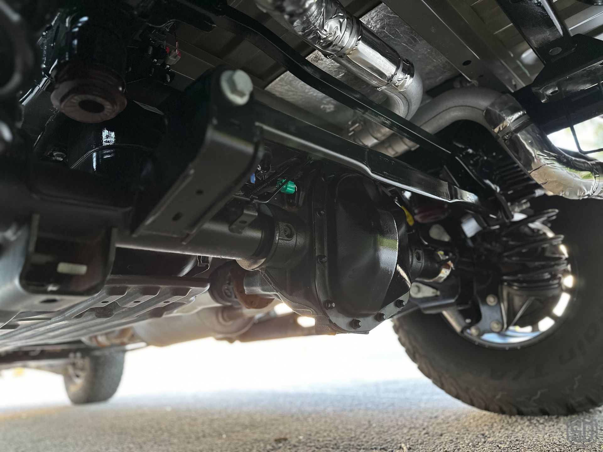 A close up of the underside of a truck 's axle