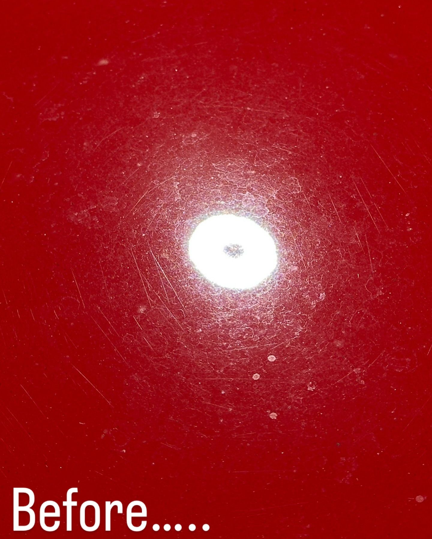 A red surface with a white circle in the middle and the words before below it