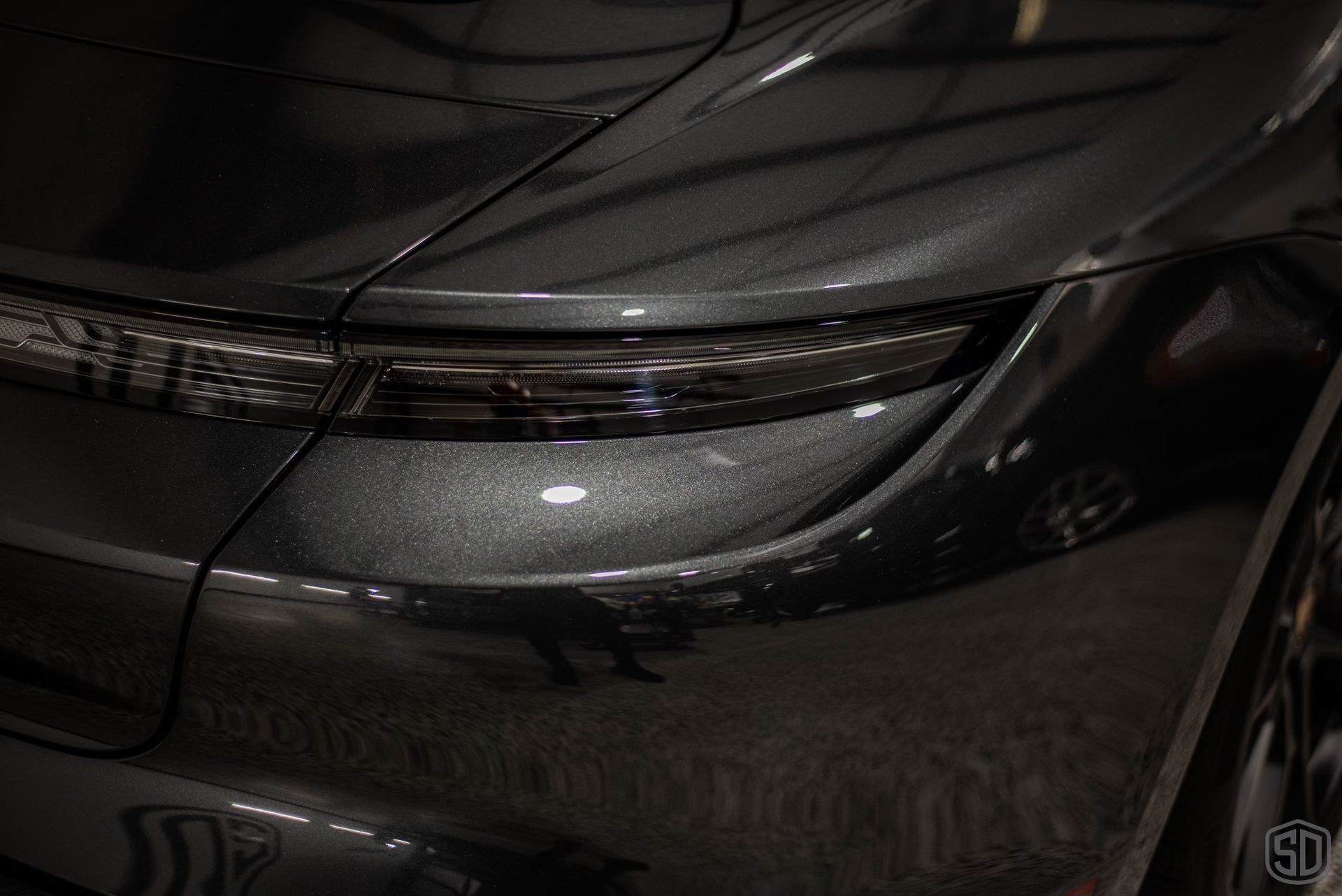 A close up of the rear end of a black car.