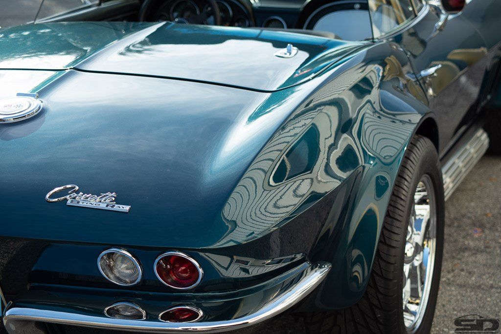 A blue corvette is parked in a parking lot