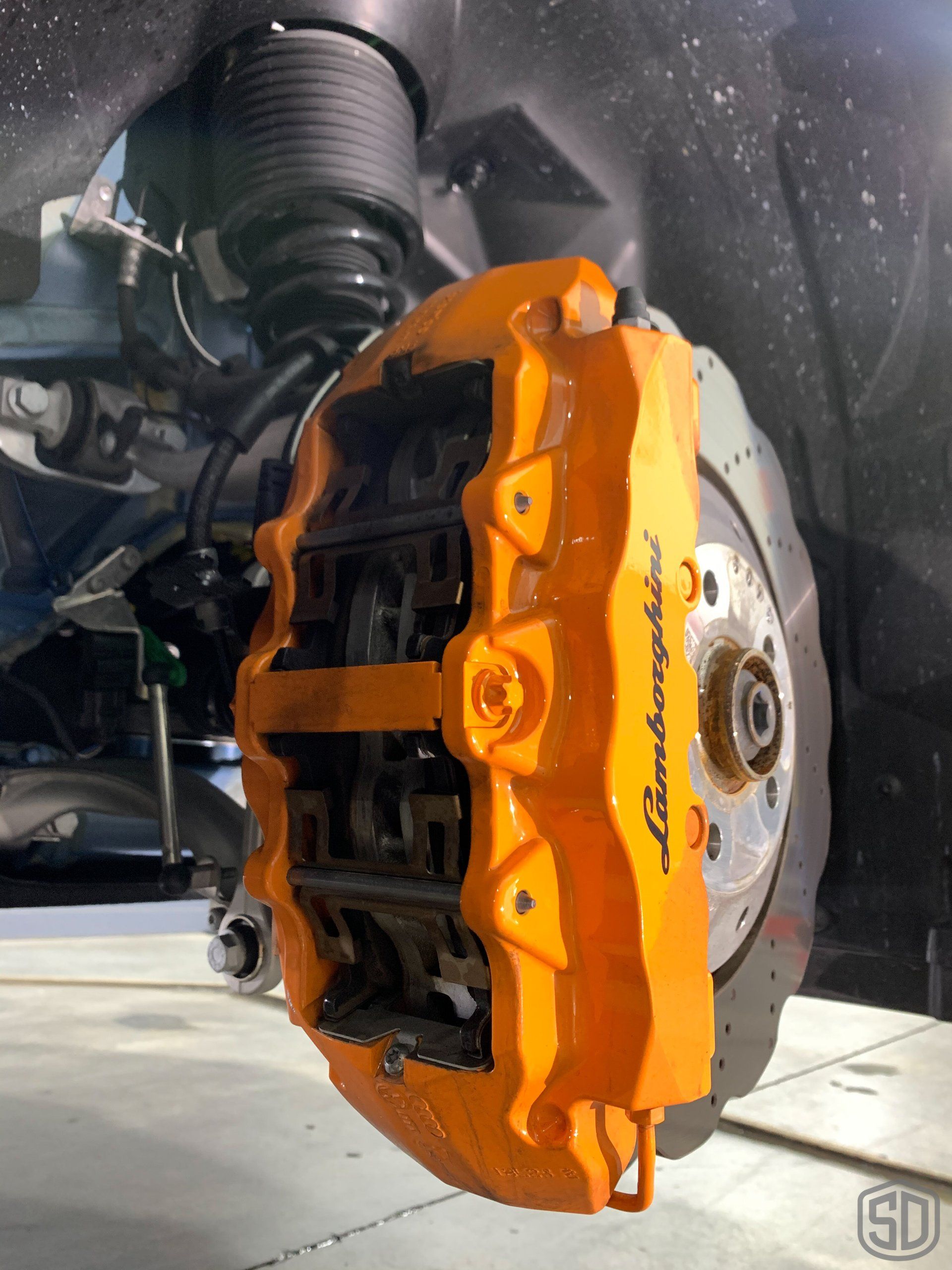 A close up of a lamborghini brake caliper on a car