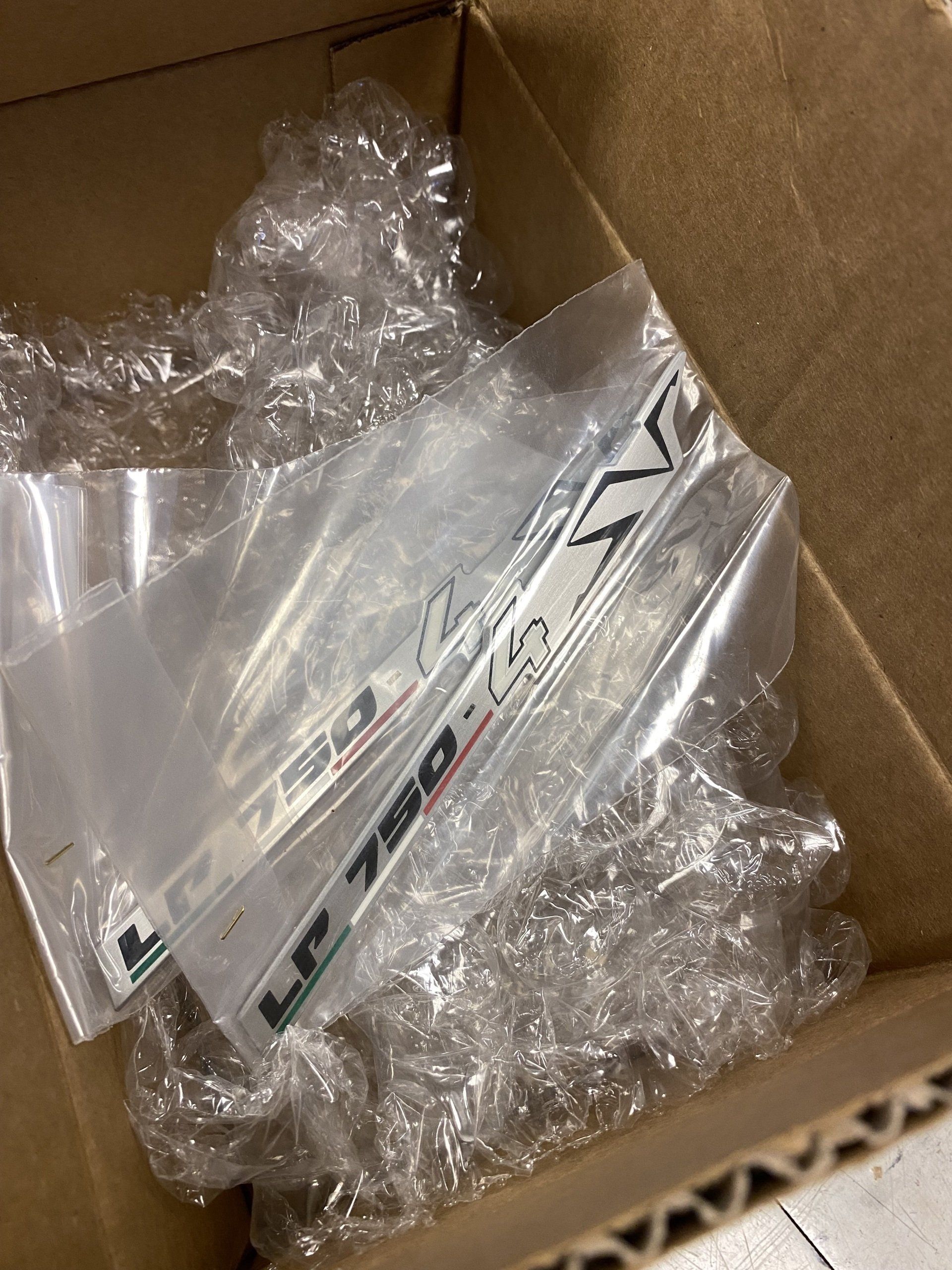 A cardboard box filled with plastic wrap and a sticker that says lp 750