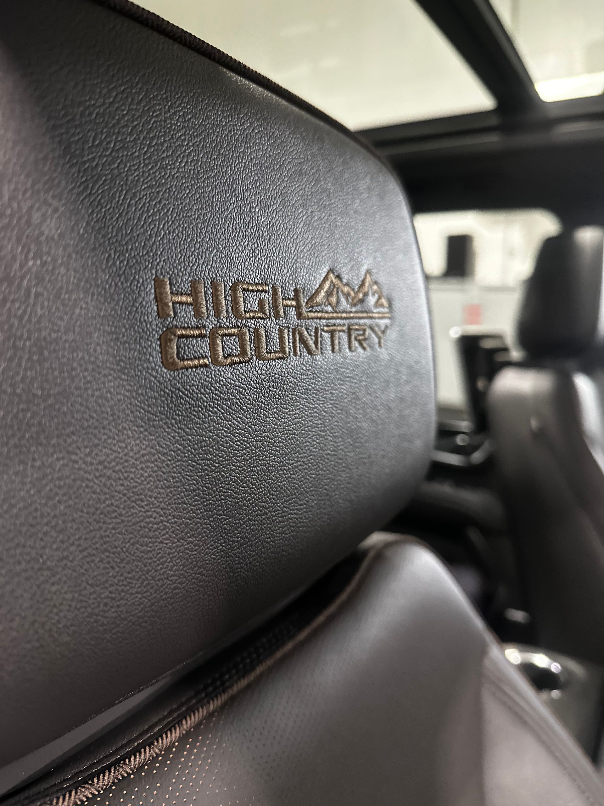 A close up of the back seat of a car with a high country logo on it.