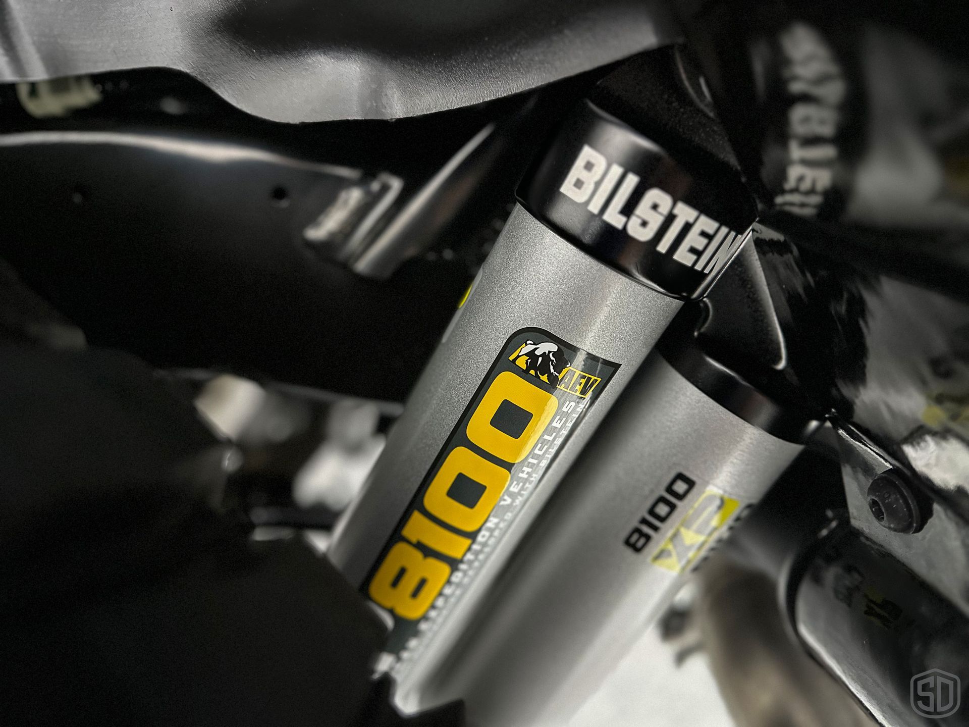 A close up of a bilstein shock absorber on a vehicle