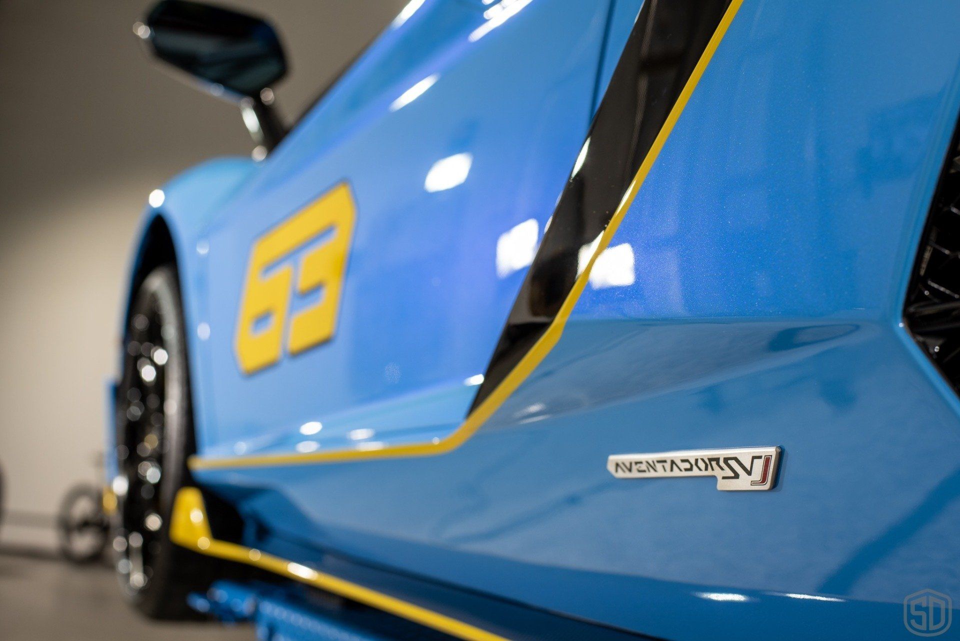 A blue sports car with the number 69 on the side