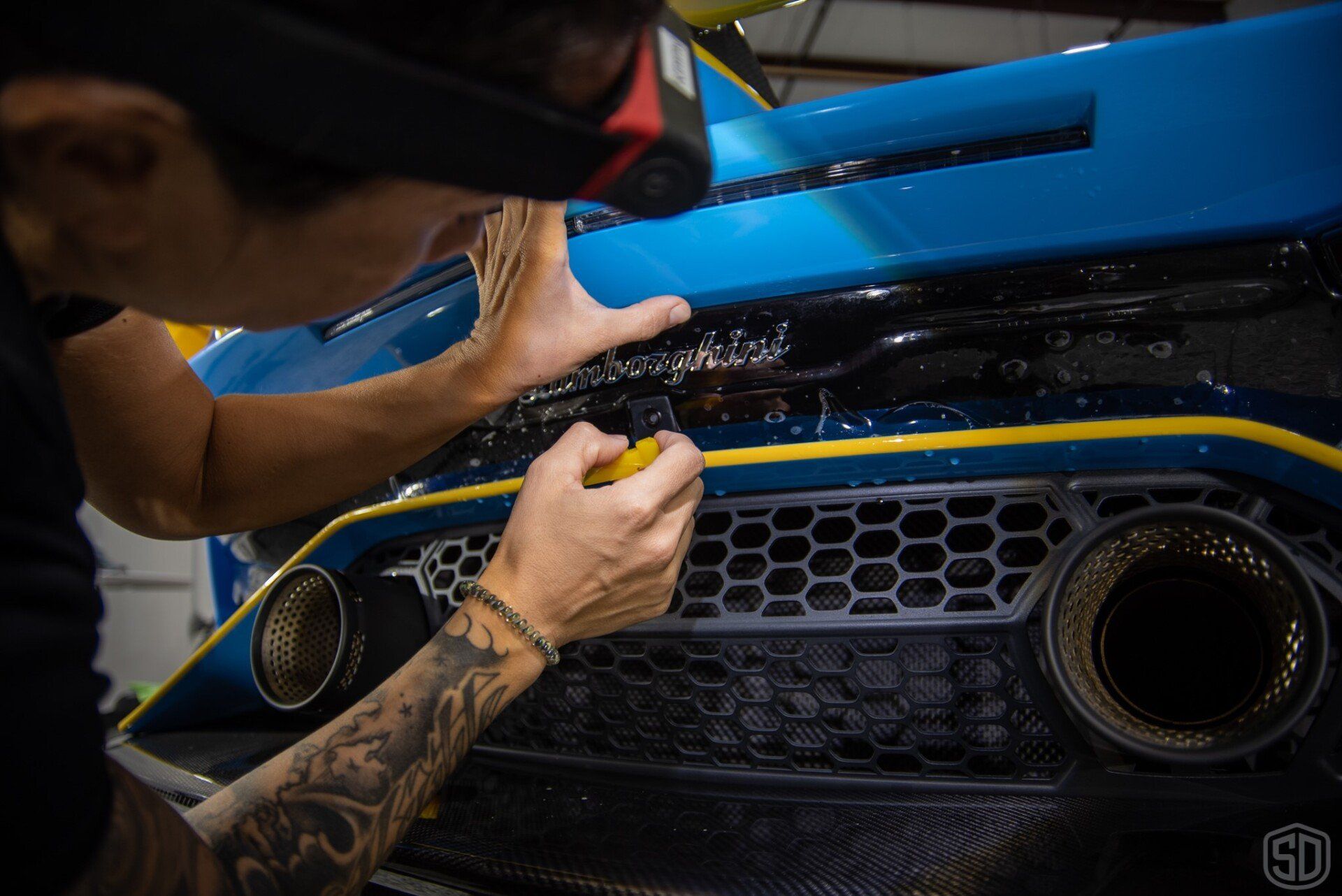 Kim applying paint protection film to rear bumper