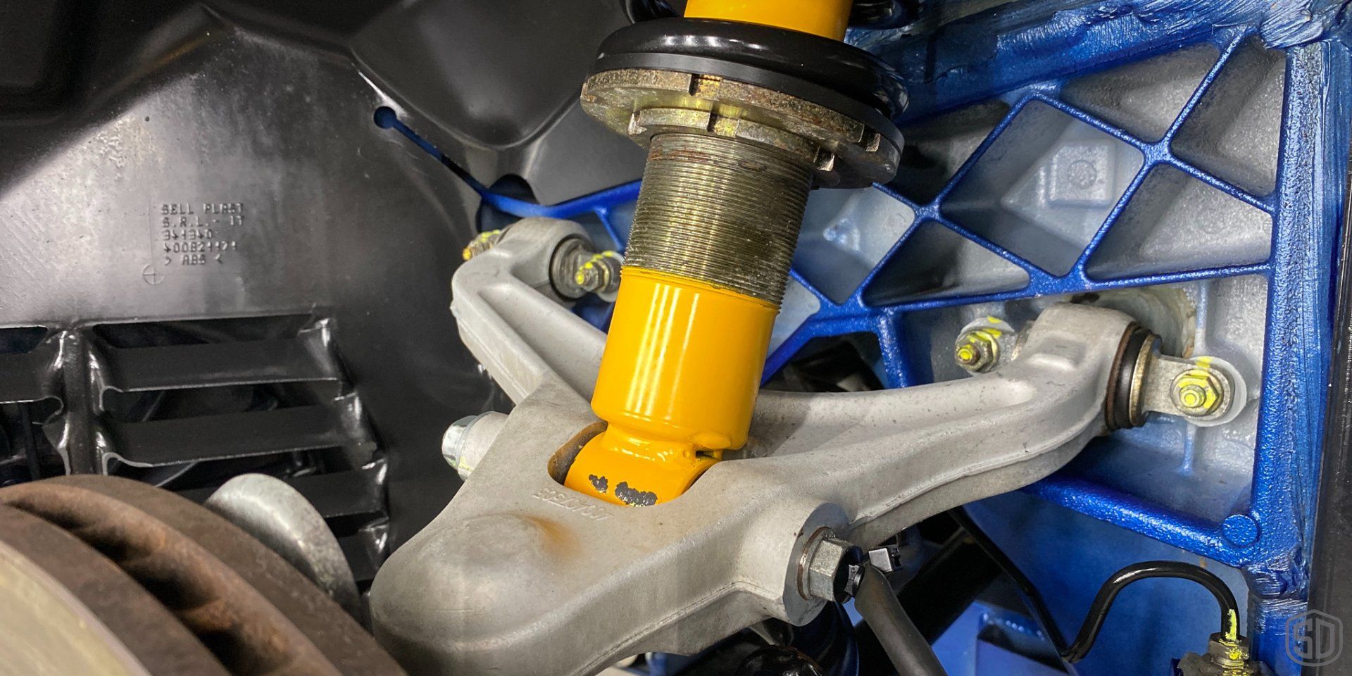 A close up of a shock absorber on a car.