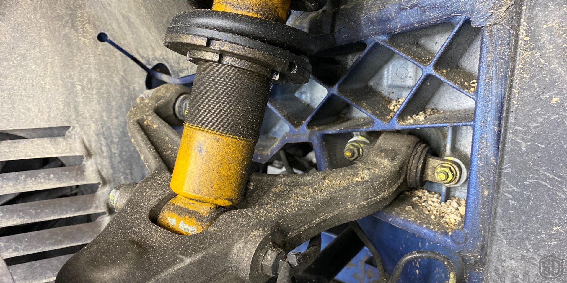 A close up of a shock absorber on a car.