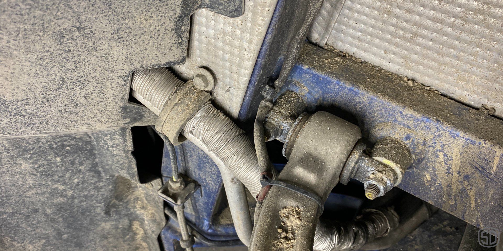 A close up of a piece of metal with a hose attached to it.