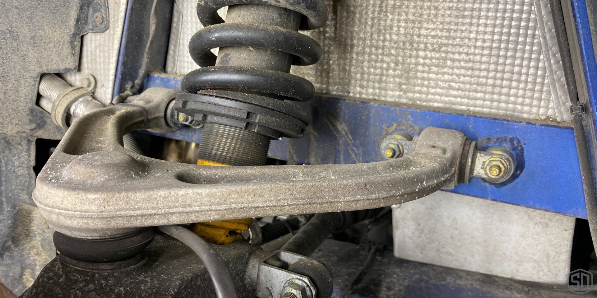 A close up of a shock absorber on a car.