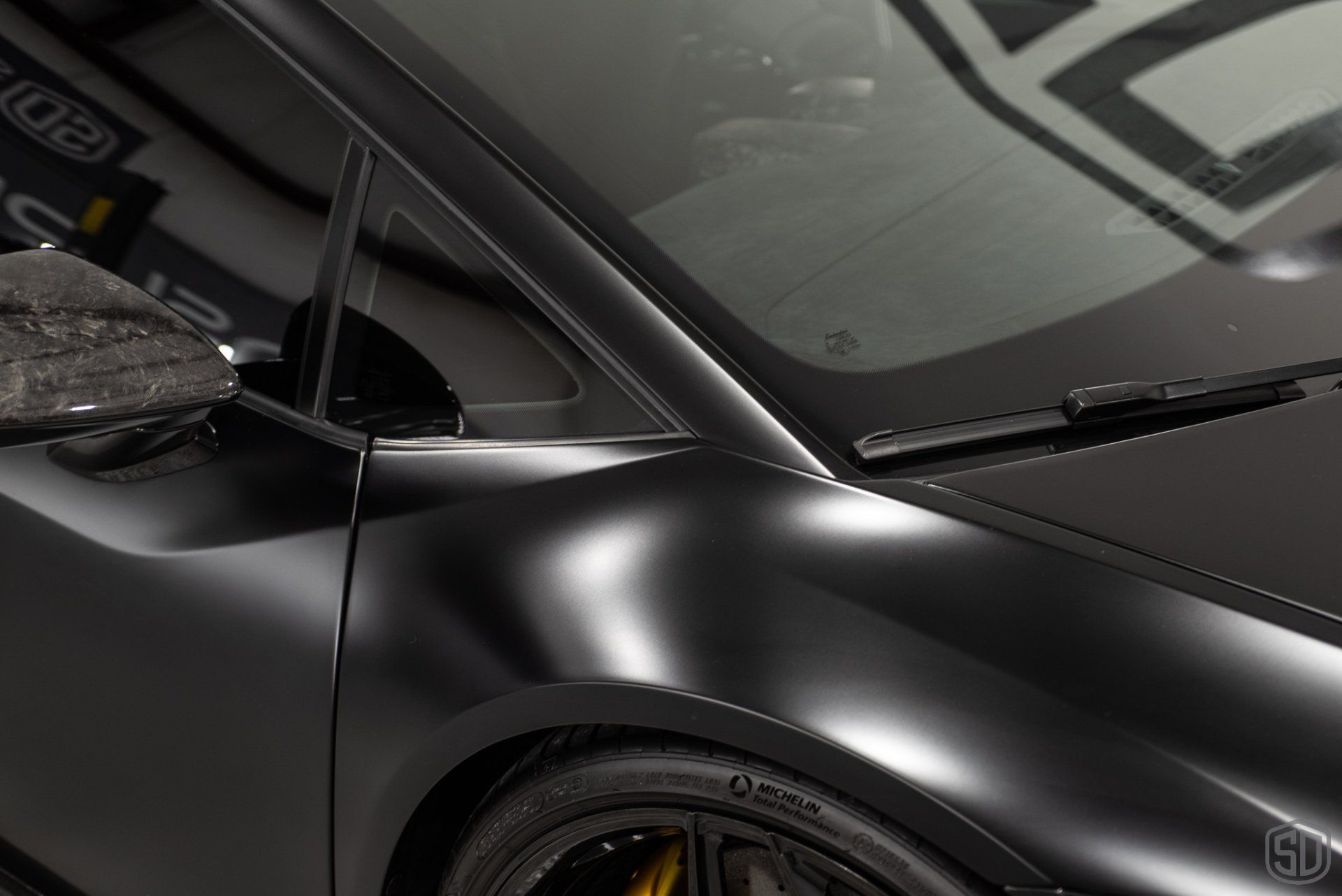 A close up of a black car with a wiper on it