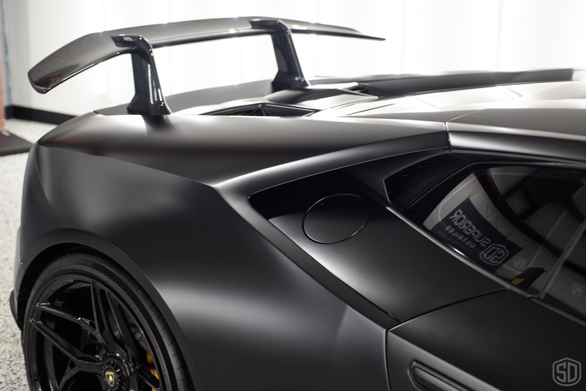 A black sports car with a spoiler on the back